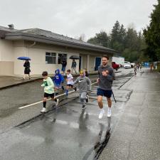 Teacher runs alongside students for Terry Fox run.